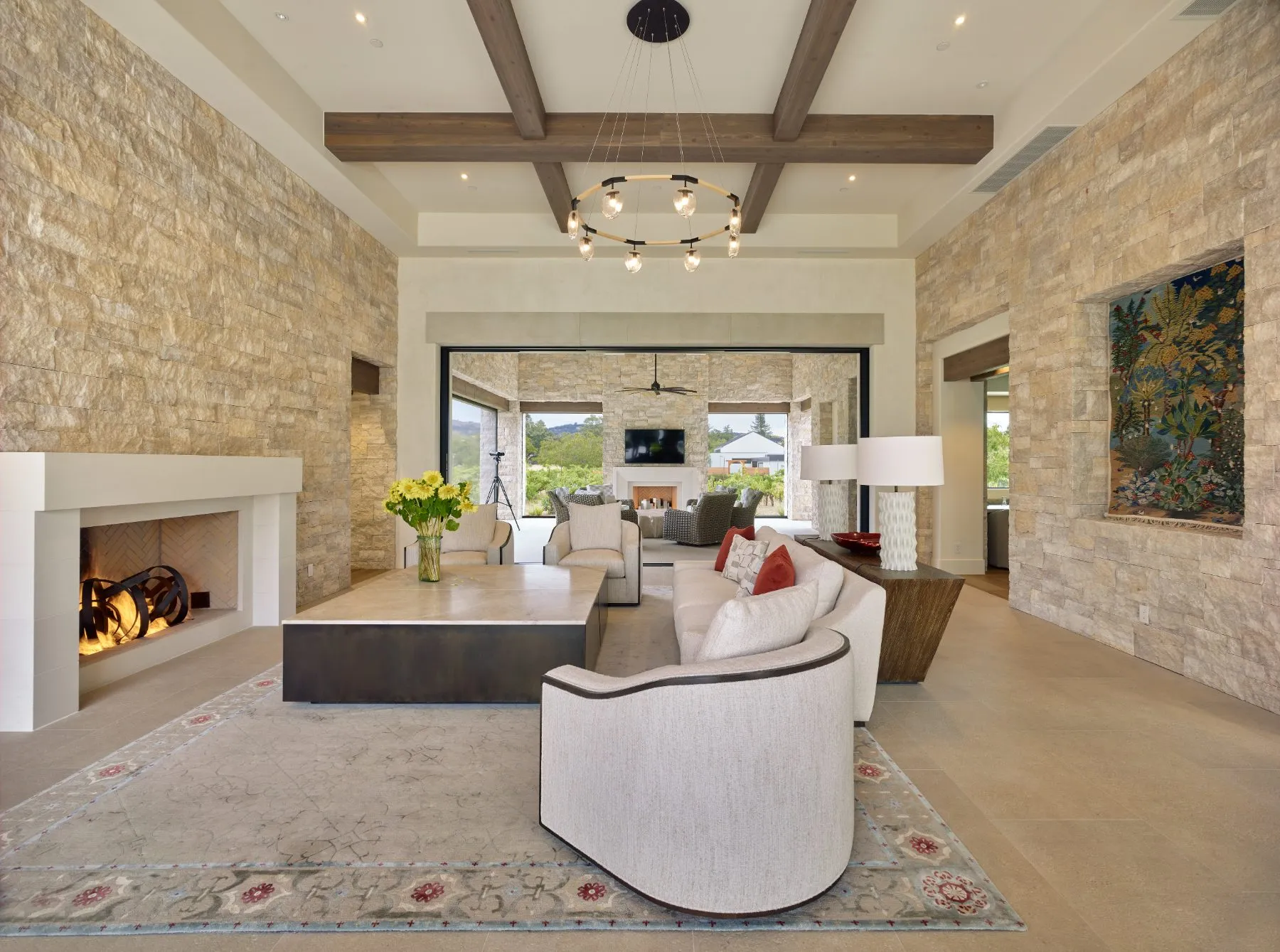 Living room with a stone fireplace in a completed home