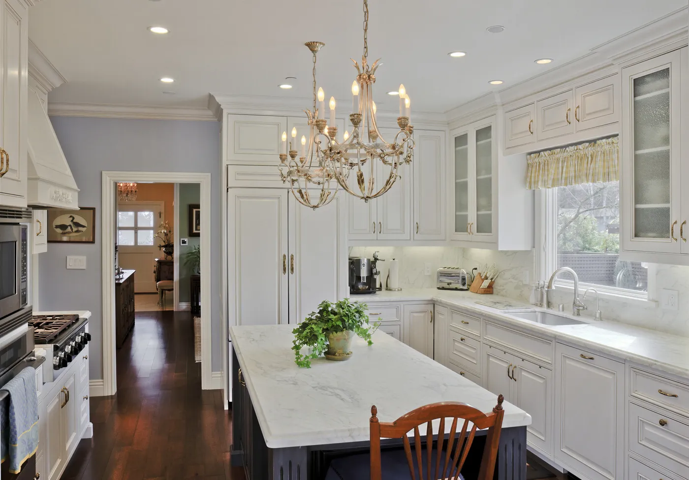 Long marble island and sink run below the garden window