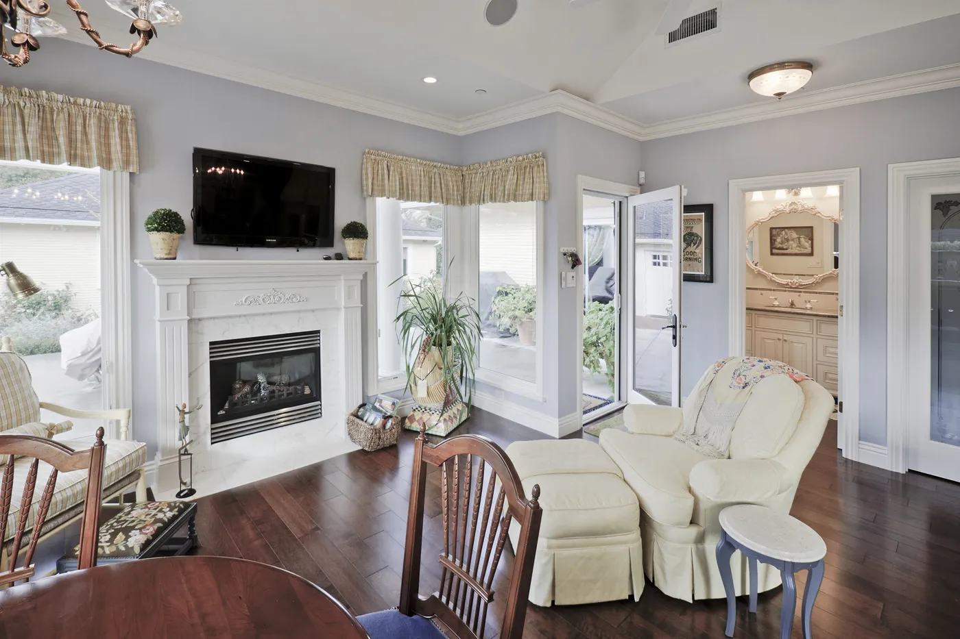 Family room fireplace with French doors to the terrace alongside