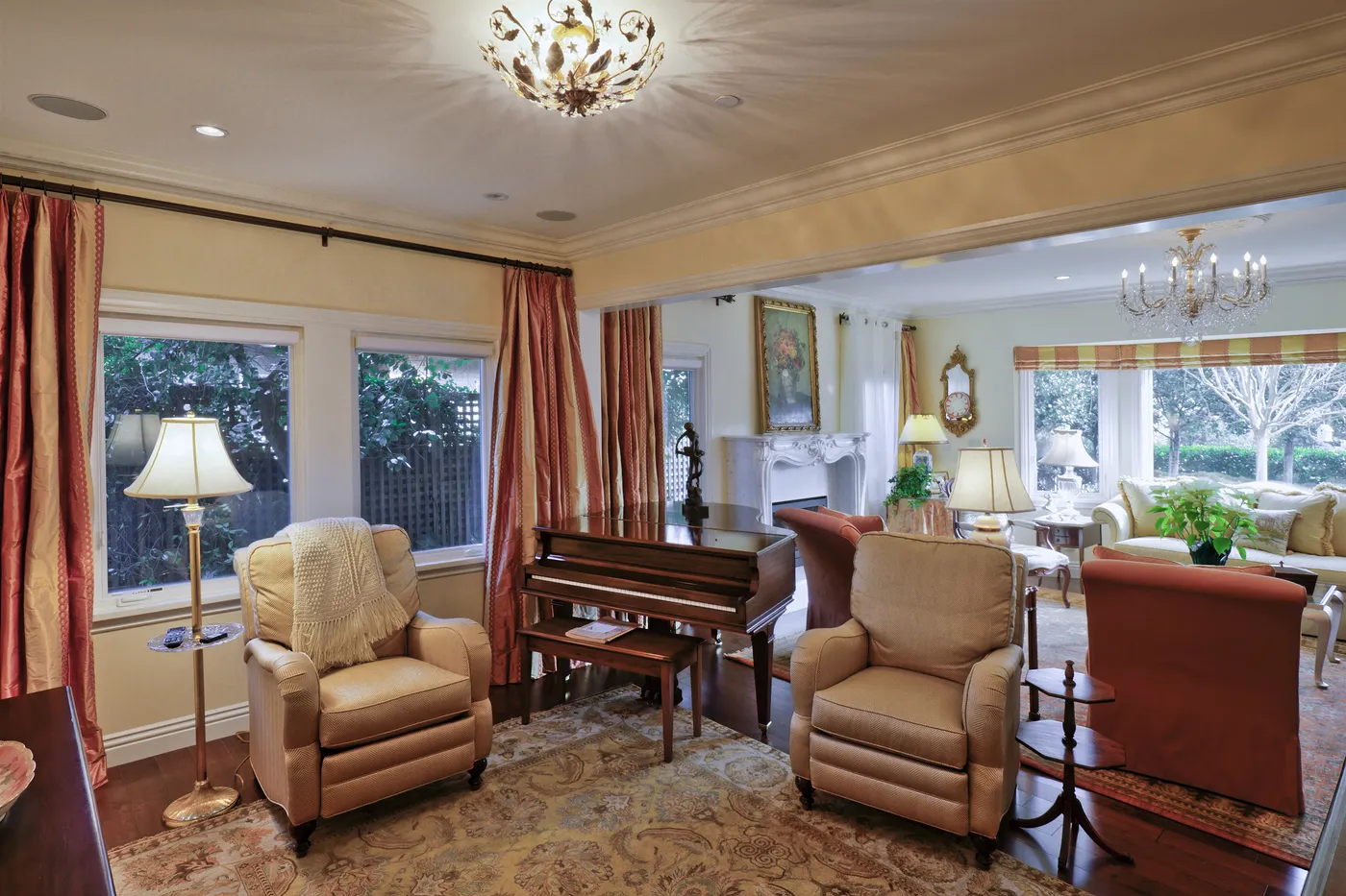 Sitting room with a piano, open through to the living room beyond