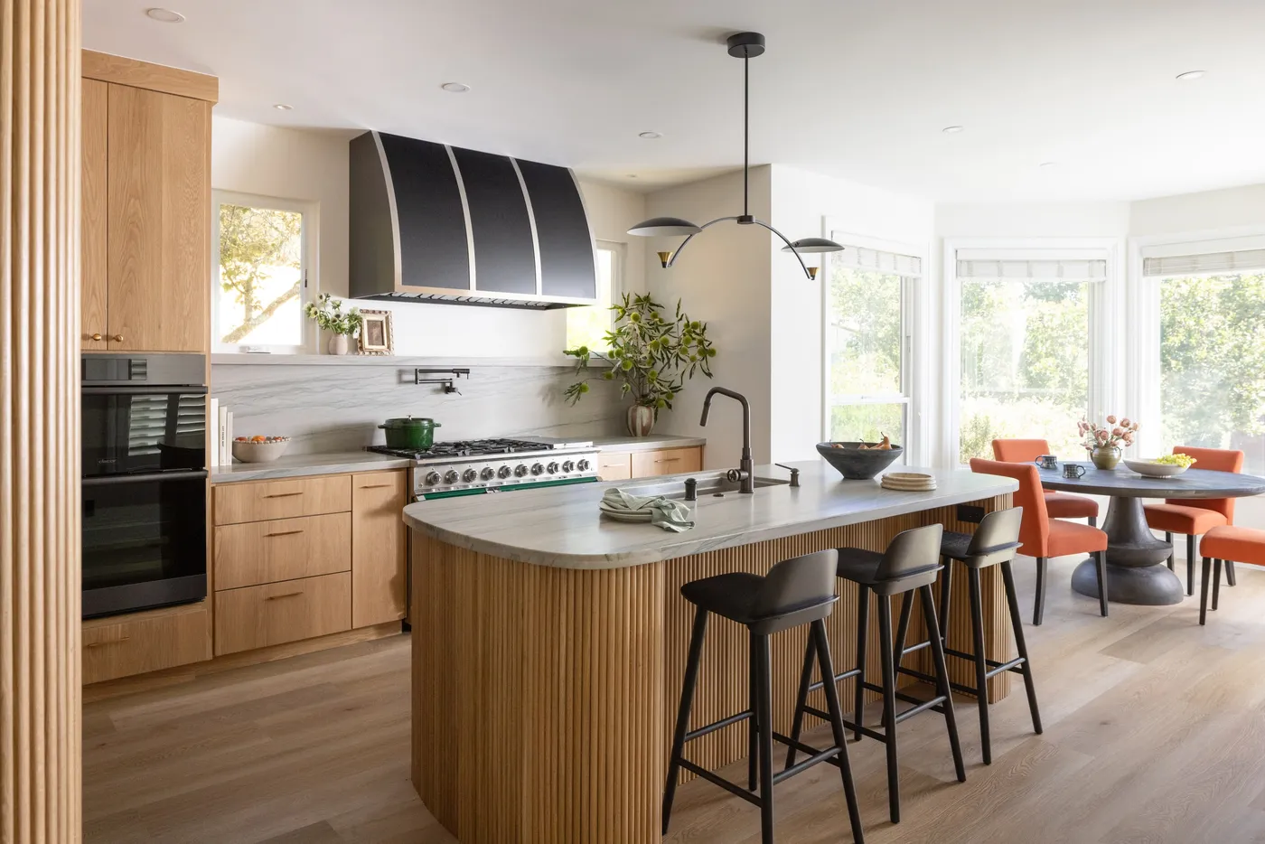 The finished kitchen opening to a bright breakfast nook