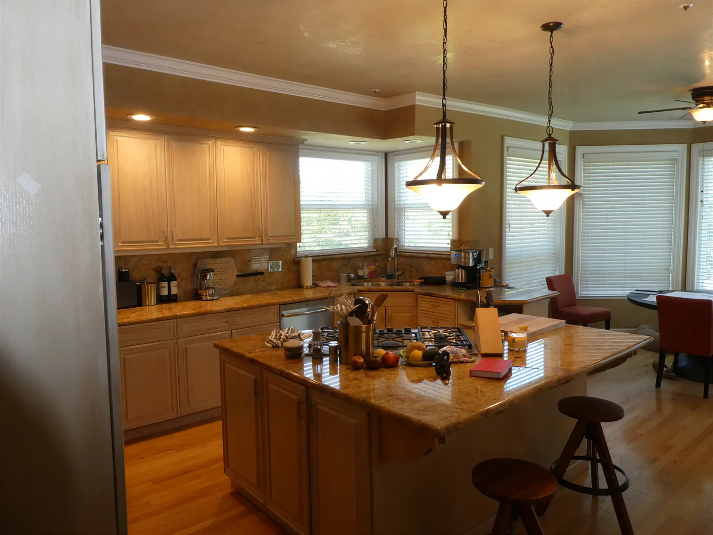 Before the remodel — light oak cabinets and a granite peninsula
