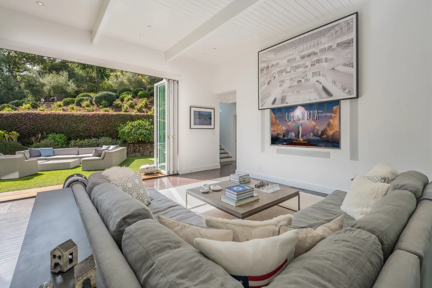 The same living room with a panoramic artwork above the console