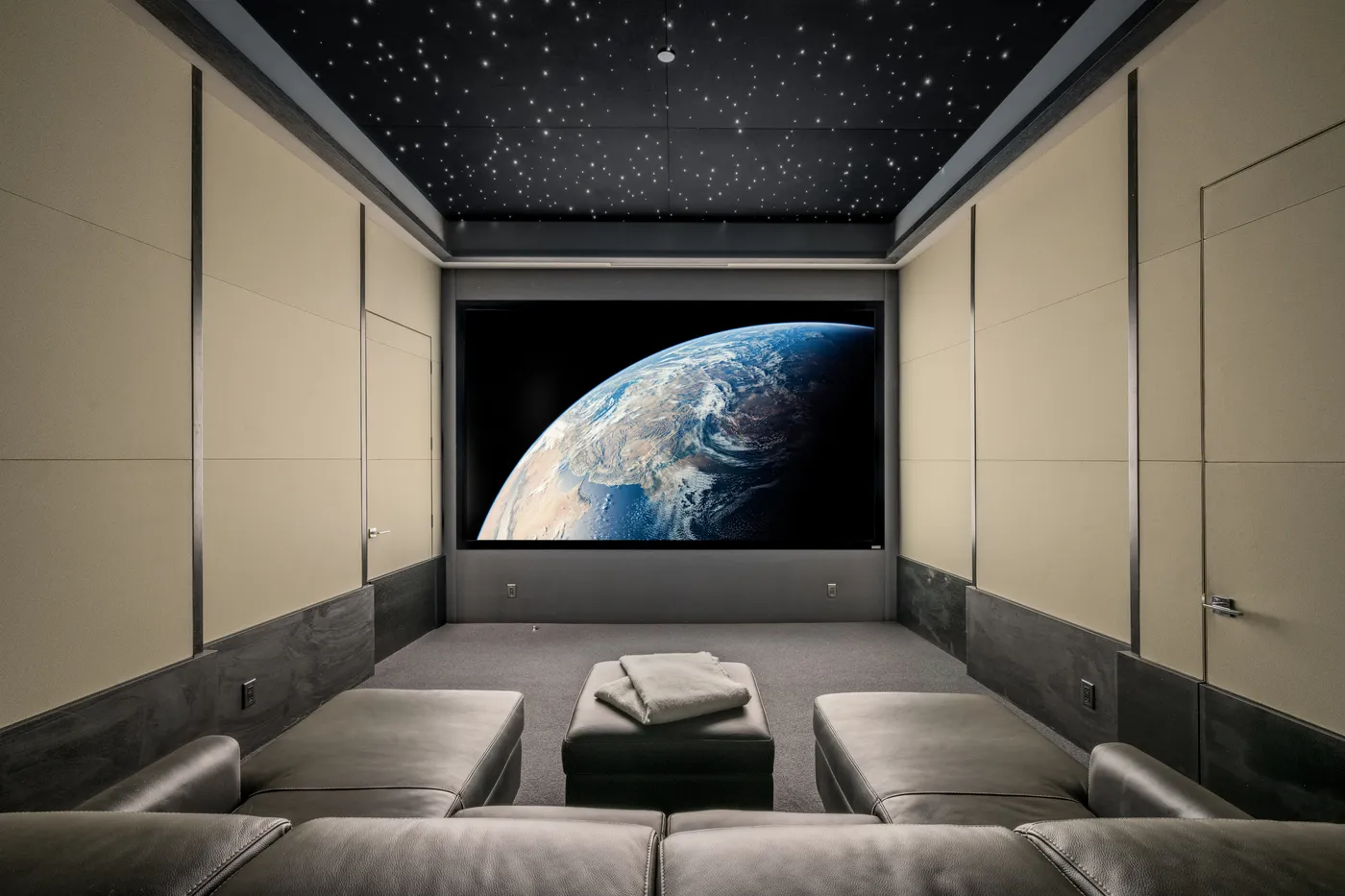 Home theater with a star-field ceiling and a large screen