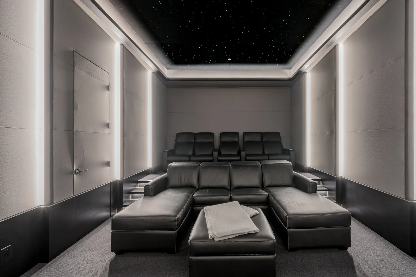 Tiered recliners in the home theater under the star-field ceiling