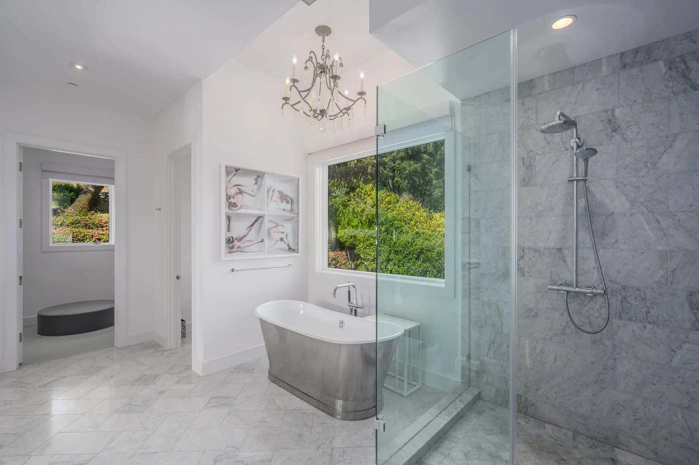 Principal bath in marble with a freestanding tub and a glass shower