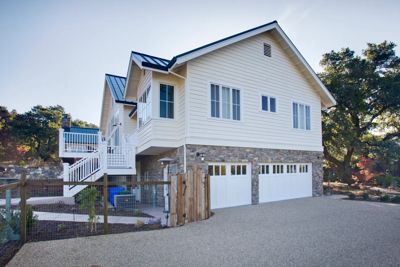 Side elevation with an exterior stair to the deck and a standing-seam roof