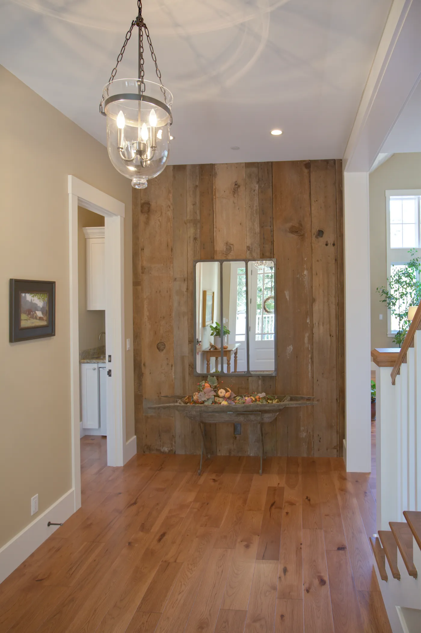 Entry hall with a reclaimed timber wall, console table and glass lantern