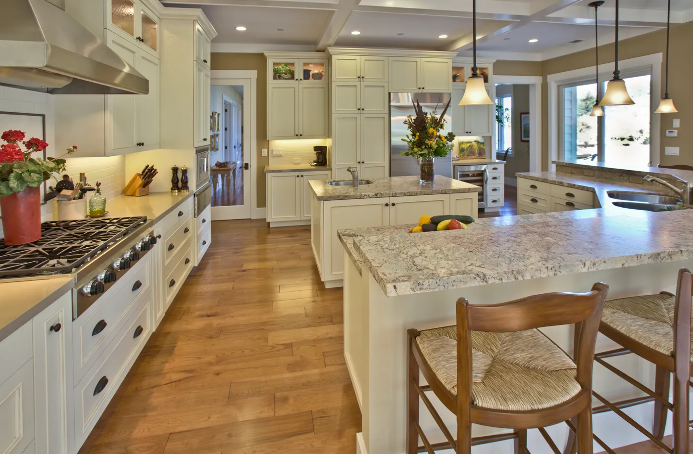 Kitchen from the range side, a second island with a prep sink beyond