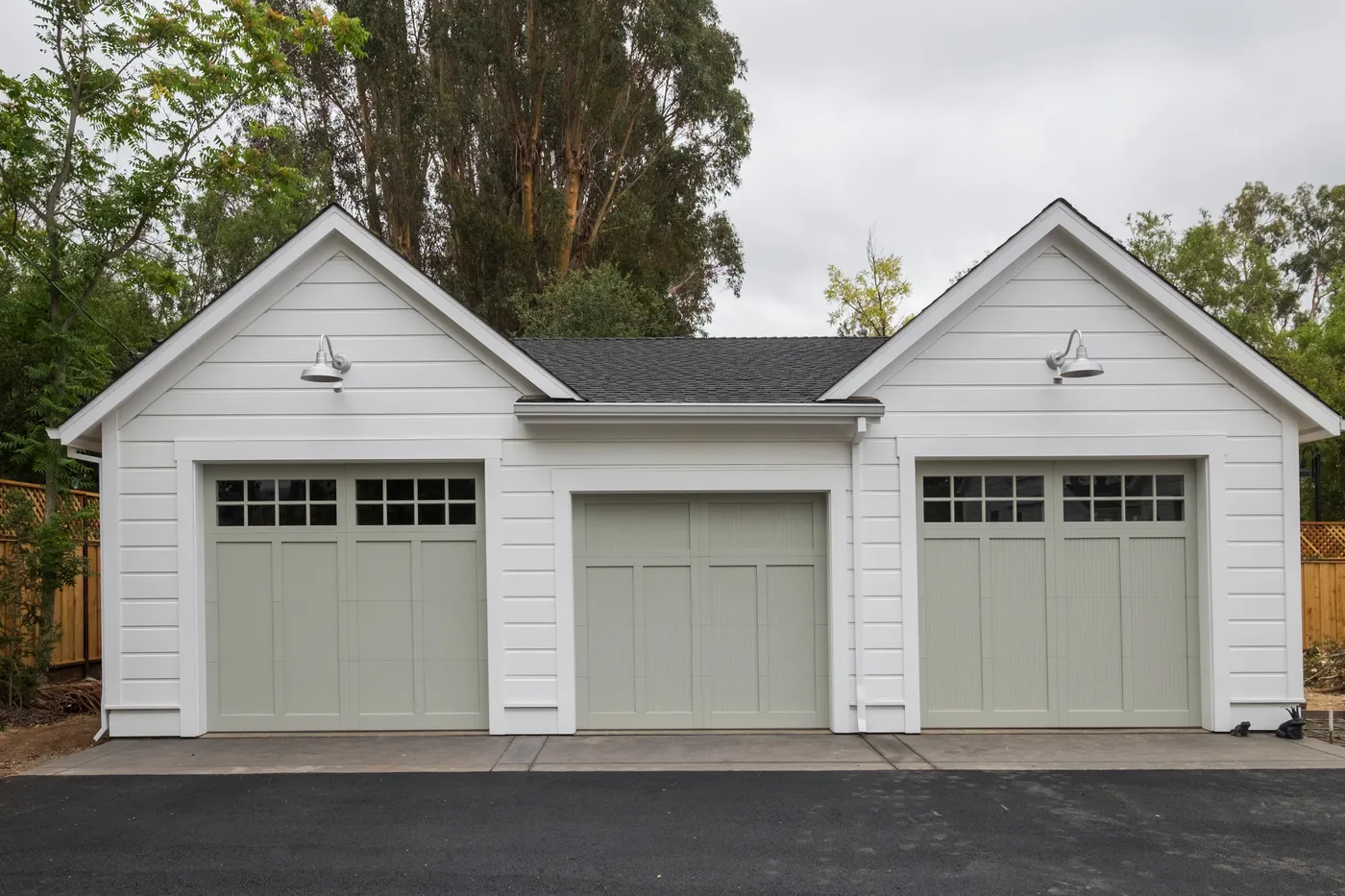 Detached three-bay garage with sage carriage-style doors