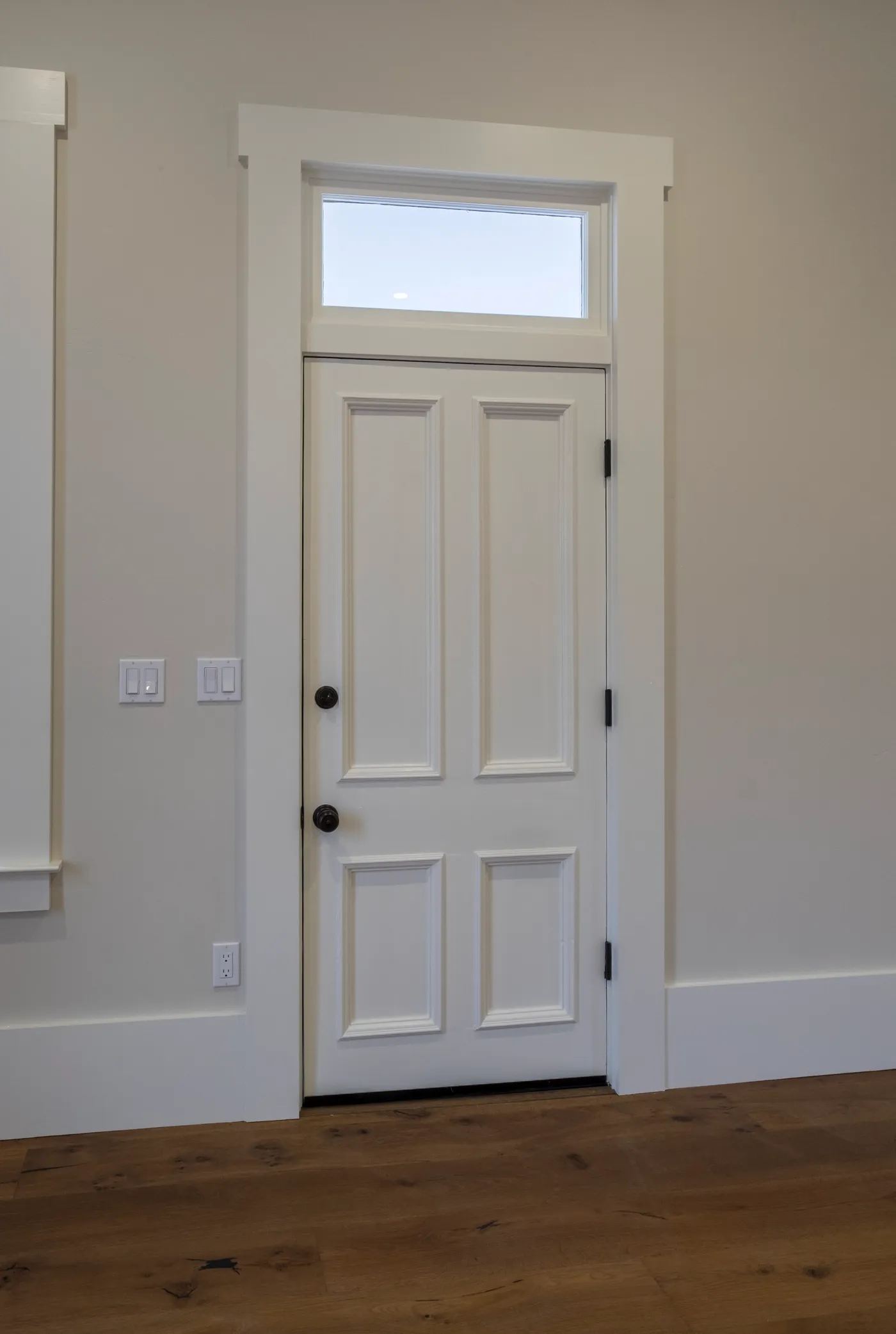 Panelled interior door below a glazed transom