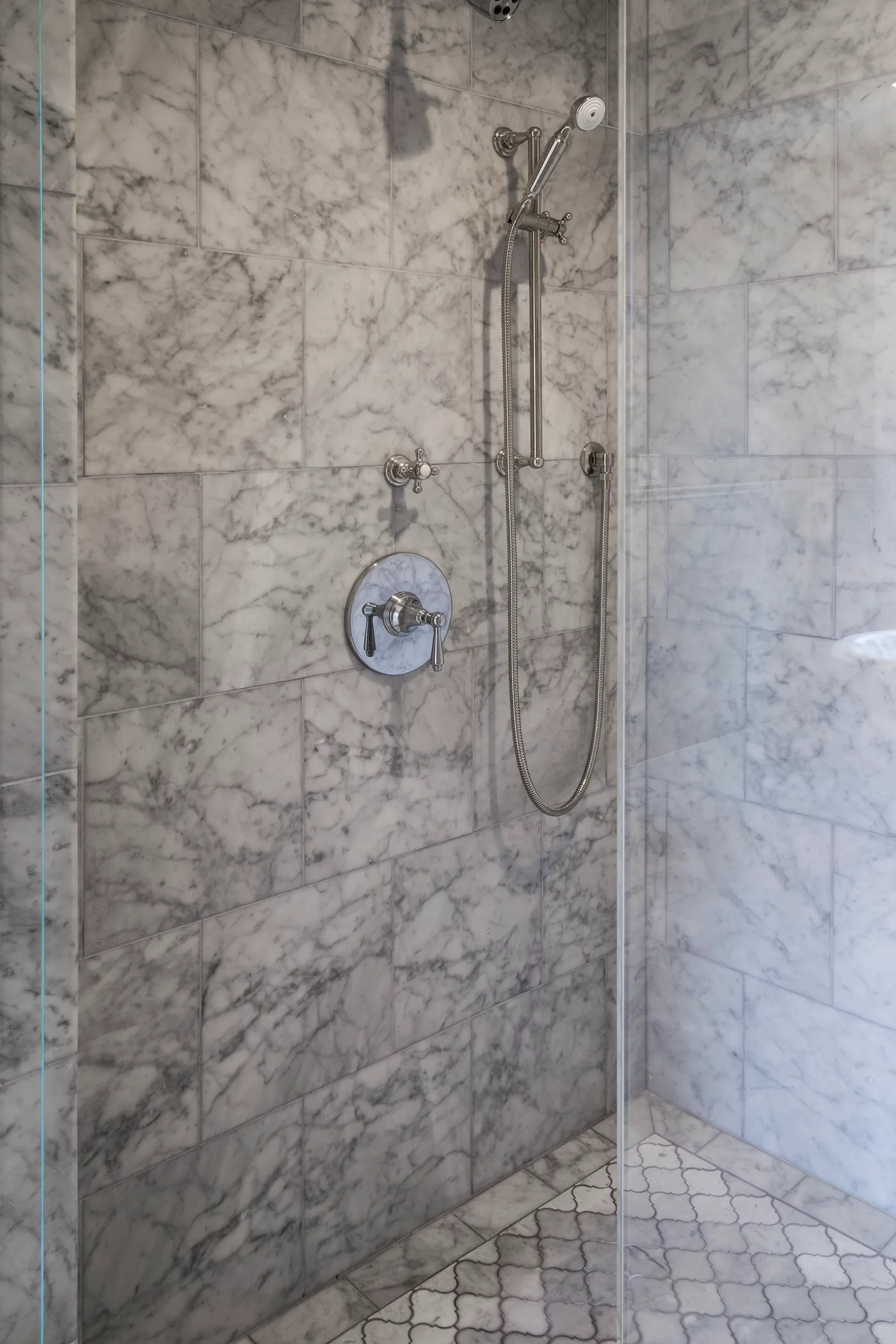 Shower fittings and handshower against the marble wall