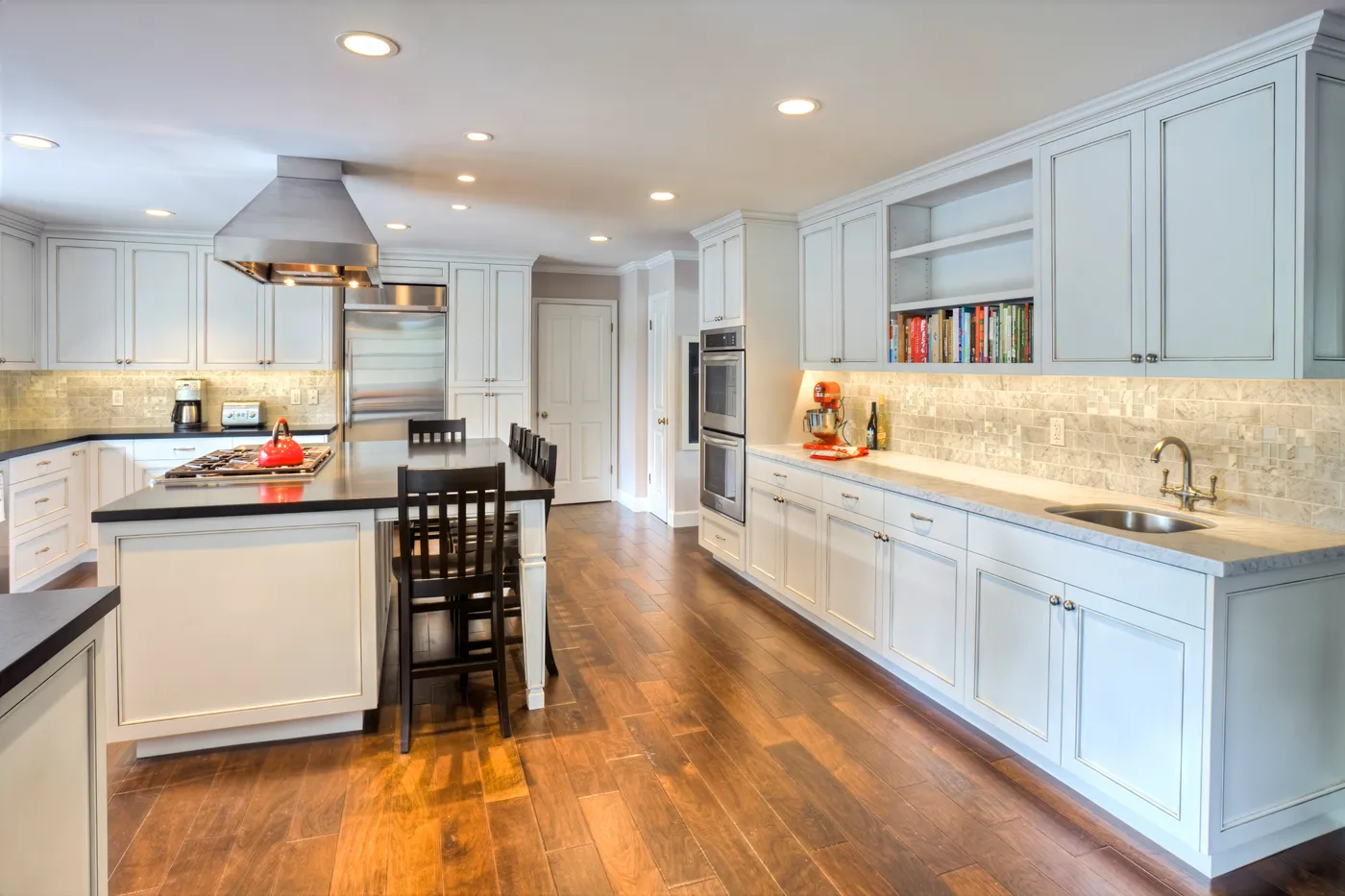 The length of the kitchen, from the island past the wall ovens to the counter beyond