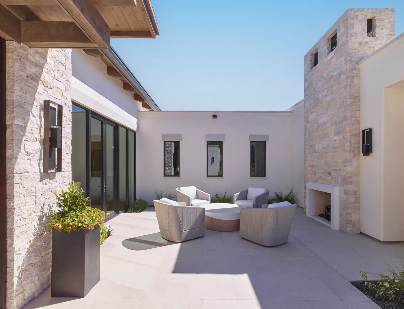 Courtyard seating around an outdoor stone fireplace