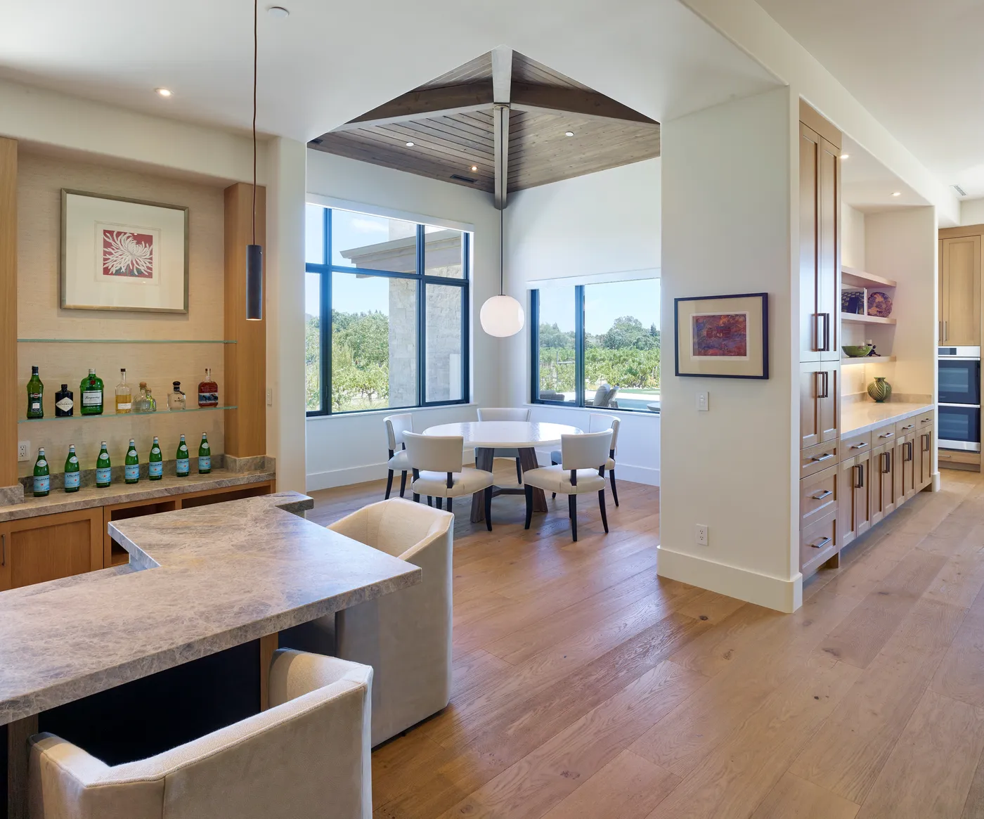 Bar and breakfast area with a round table in the window bay