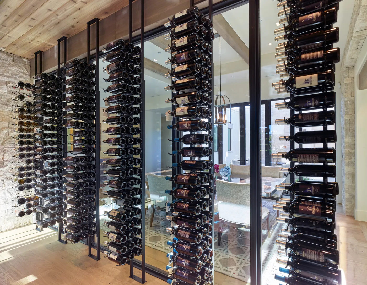 The glazed wine wall seen from the dining room, racked full of bottles