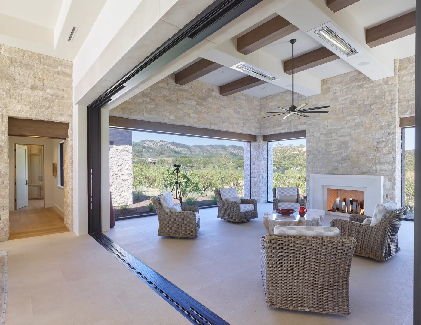 The loggia seen from inside, the pocket doors folded fully open to the hills