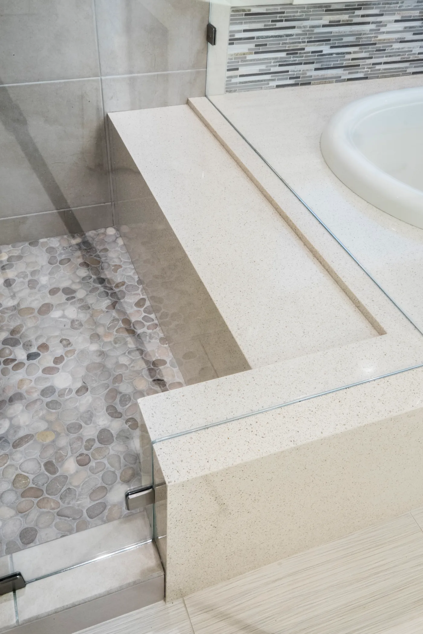 Close up of mitered stone bench detail in shower.